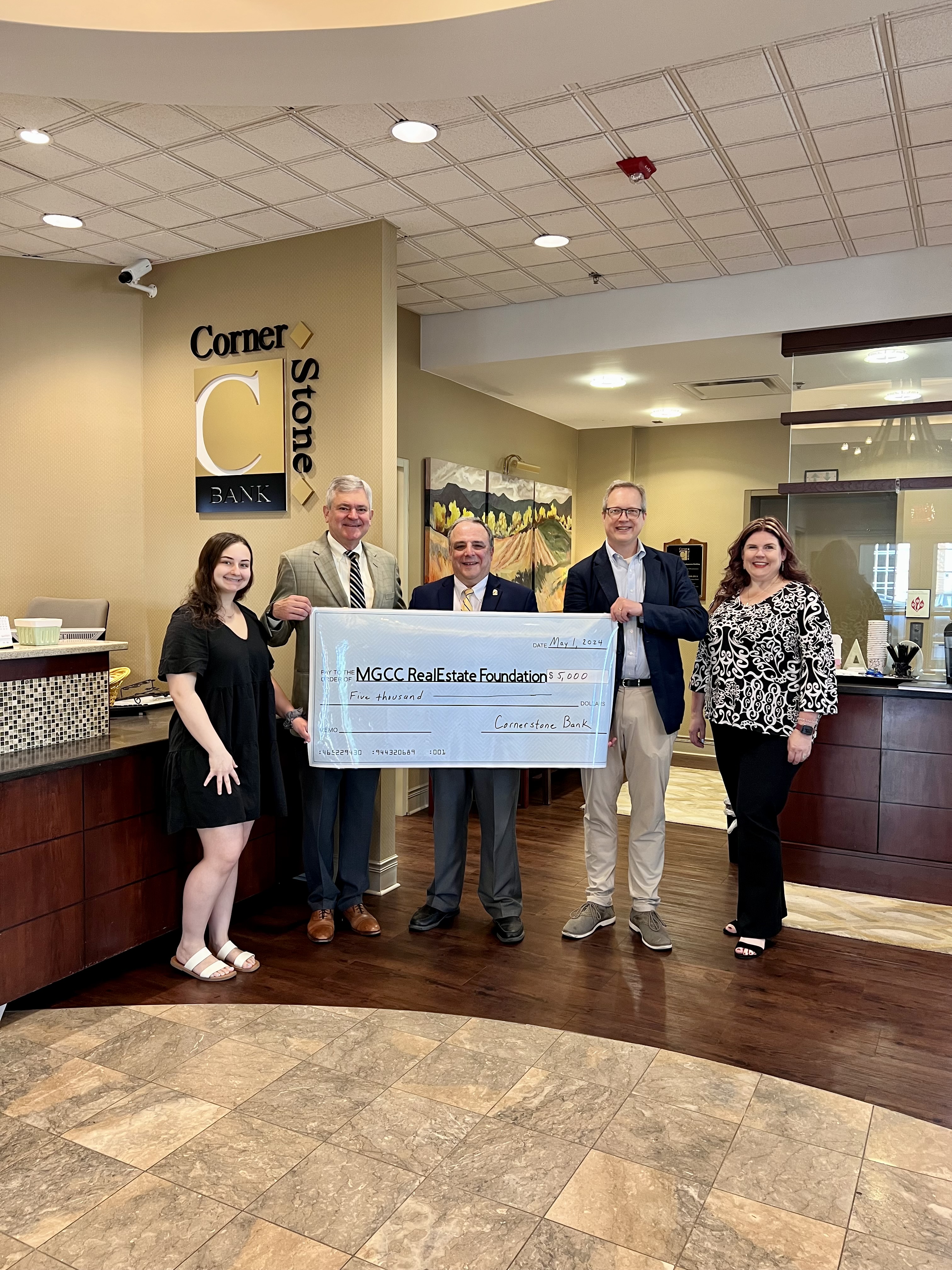 CornerStone Bank officials pose with MGCC President and VP of Academic Affairs for a check presentation