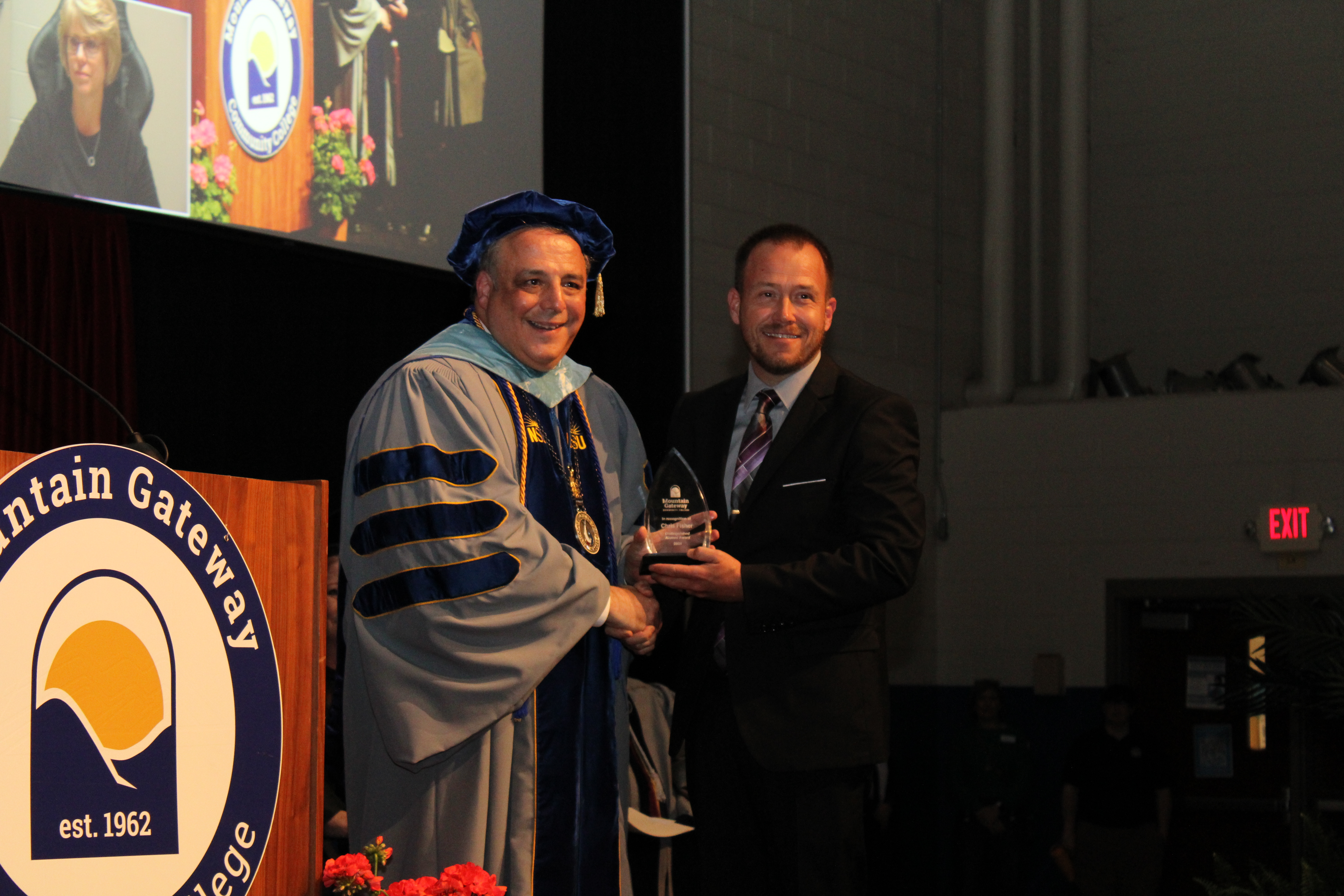 Chris Fisher receives the Distinguished Alumni Award from Dr. John Rainone
