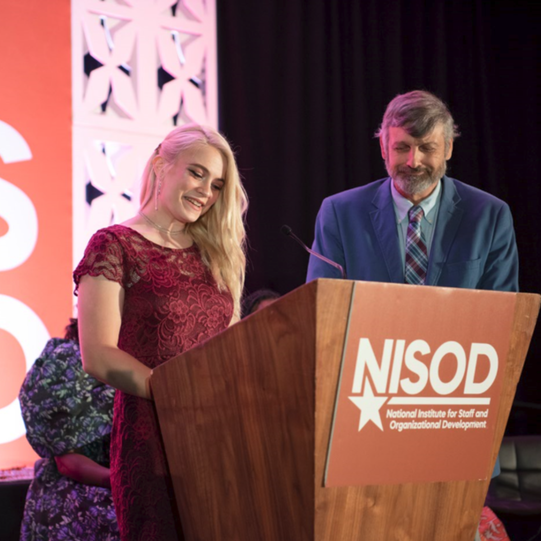 Katie Shofstahl stands with welding instructor Mike Bryant at the NISOD conference in Texas.