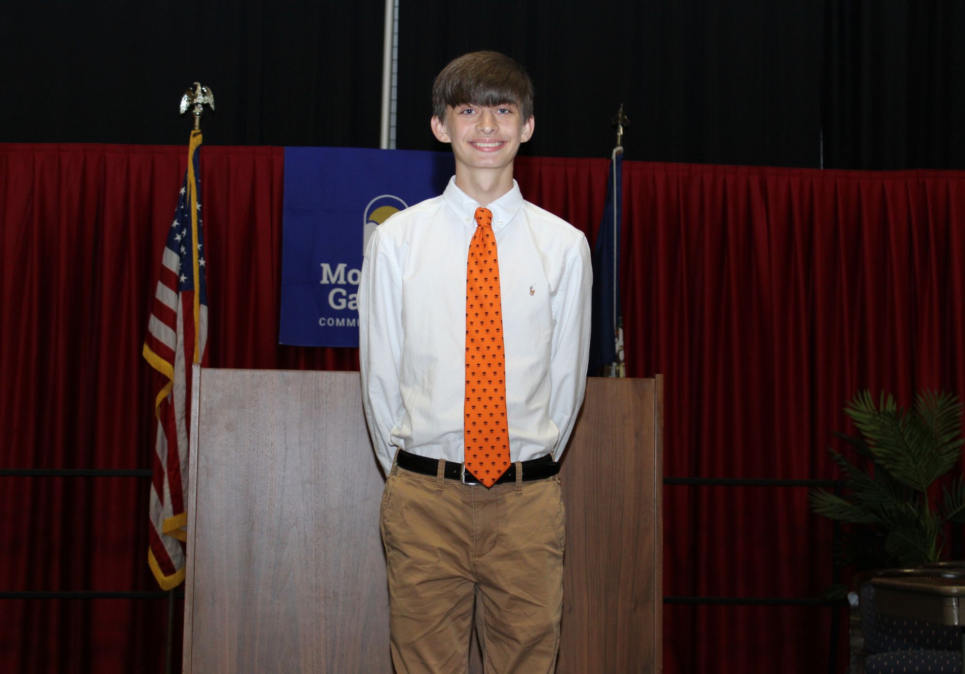 Zachary Vernon stands in the center of a stage.